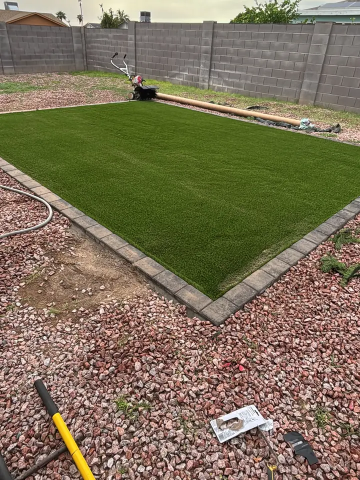 After: artificial turf installed inside the paver border
